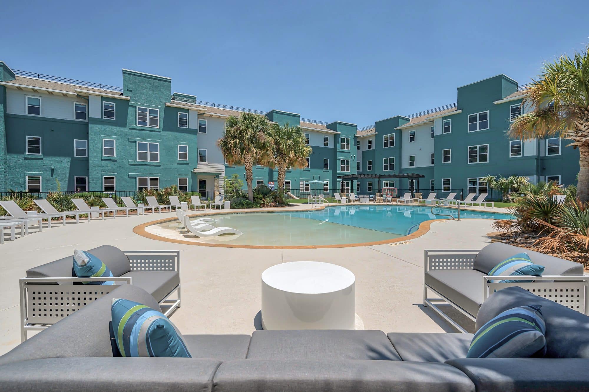 Pool and an exterior view of the student apartments at Cambridge Hall in College Station.